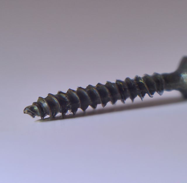 Image of close up of metal screw with copy space on brown background. Screw and fixing diy items concept.