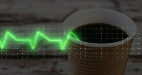 Coffee cup with ecg graph on distressed wooden table