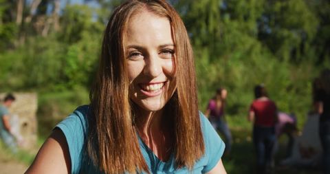 portrait of joyful woman participating in river cleanup alongside a diverse group of volunteers, enhancing the environmental landscape on a sunny day. ideal for campaigns promoting community service, environmental awareness, and team-building in nature.