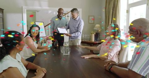 Celebrating certificate presentation at home dining table with diverse family and confetti