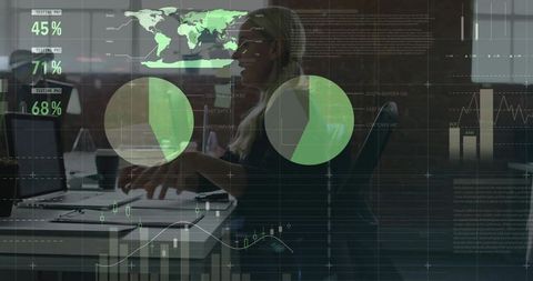 Business analyst typing at laptop with interactive data overlays, charts, maps and metrics