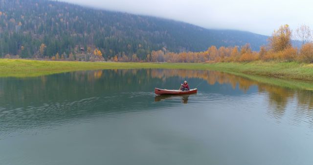 Solo Kayaker Paddling on Serene Lake in Autumn - Download Free Stock Photos Pikwizard.com
