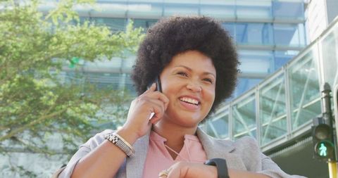 Confident Businesswoman Talking on Smartphone Checking Smartwatch