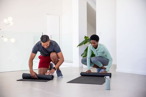 Diverse Friends Preparing for Yoga at Home in Modern Living Space