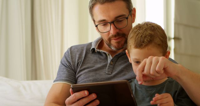 Father and Son Bonding Time Using Digital Tablet at Home - Download Free Stock Images Pikwizard.com