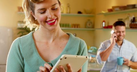 Woman Using Tablet in Bright Kitchen Environment