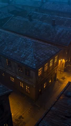 Vertical Descent Revealing Lit Corner Building, Streetlamp Glow and Wet Rooftops