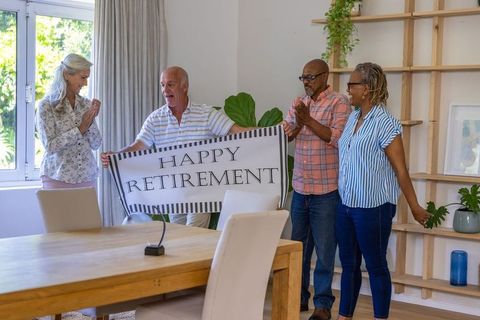 Happy retirement celebration among senior friends at home