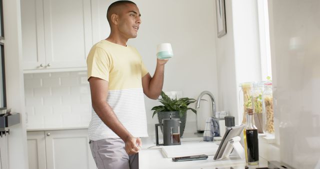 Man Having Breakfast and Enjoying Morning Beverage in Modern Kitchen - Download Free Stock Images Pikwizard.com