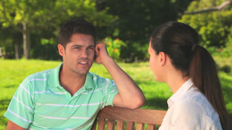 Couple Enjoying Conversation on Park Bench