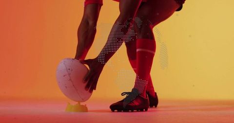 Rugby Player Setting Ball Before the Kick in Studio with Digital Overlay