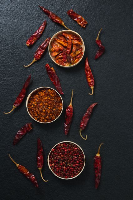 Overhead of dried red chili pepper and crushed red pepper in bowl