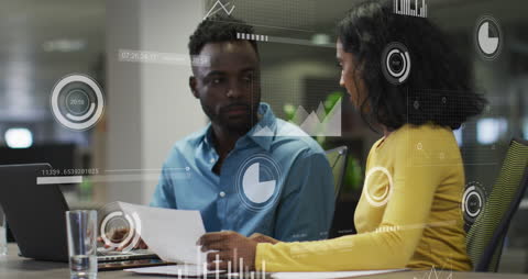 Diverse Business Team Analyzing Documents with Digital Interface