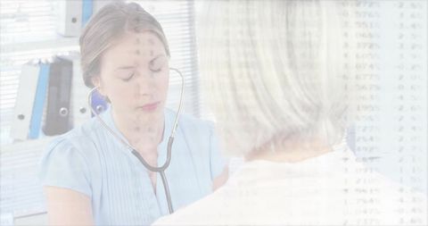 Nurse Performing Heart Check With Stethoscope in Examination Room