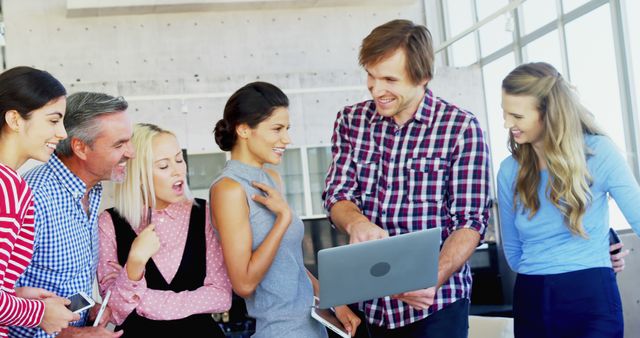 Creative Team Collaborating on Laptop Project in Modern Office - Download Free Stock Images Pikwizard.com