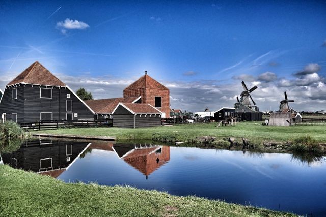 Scenic Dutch Countryside with Windmills and Farmhouses by the Water - Download Free Stock Photos Pikwizard.com