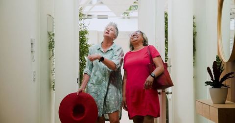 Senior couple admiring vacation stay in bright hotel entrance