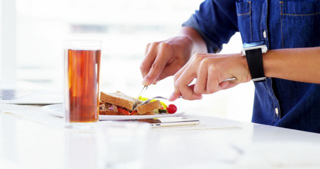 Close-up of person cutting sandwich in modern kitchen - Download Free Stock Images Pikwizard.com