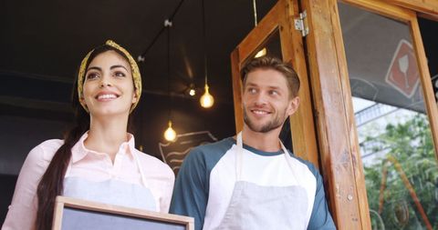 Cafe Entrepreneurs Welcoming Customers into Local Coffee Shop