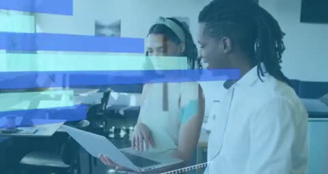 Colleagues Analyzing Data on Laptop with Digital Graph Overlay