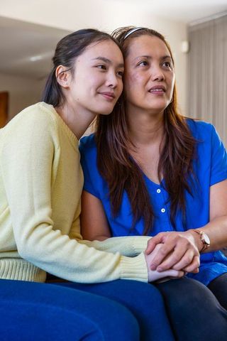 Asian Mother and Daughter Sharing a Quiet, Bonding Moment at Home