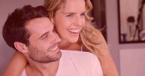 Joyful Couple Embracing with Romantic Heart Overlay