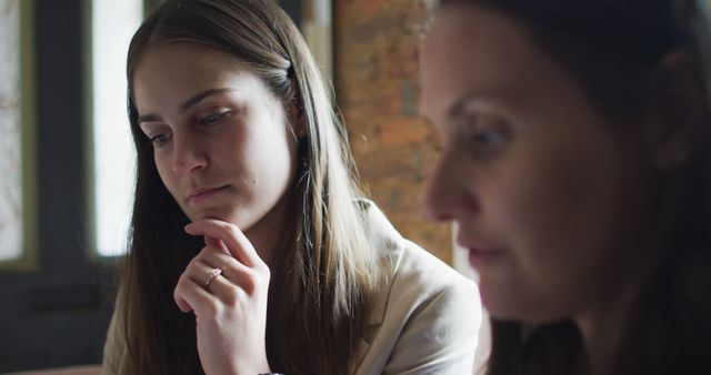 Two Women Engaged in Thoughtful Conversation - Download Free Stock Images Pikwizard.com