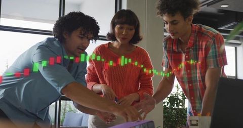 Colleagues Analyzing Candlestick Chart Data in Modern Office