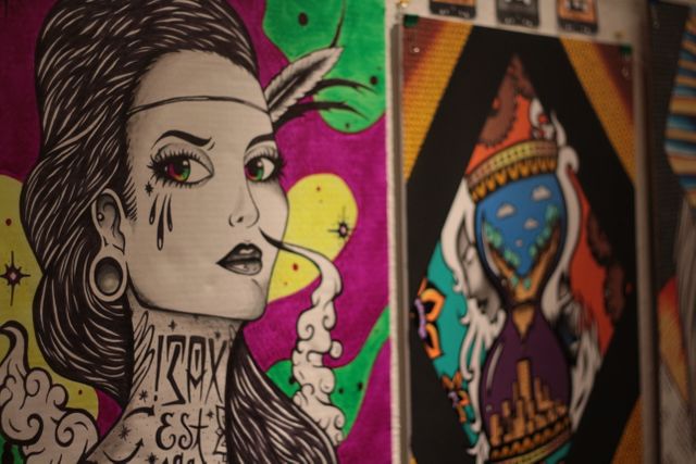 Colorful graffiti art on a wall, showcasing a tattooed woman with dramatic features and vibrant abstract designs. Could be used in articles about urban culture, street art movements, or contemporary art trends. Ideal for backgrounds or design resources highlighting modern, artistic expression in urban environments.