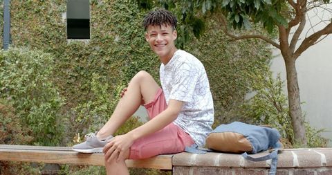 Happy Teenage Boy Smiling Outdoors on Bench - Download Free Stock Images Pikwizard.com