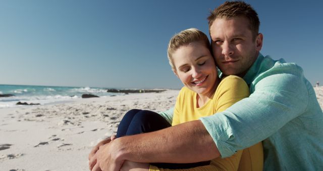 Happy caucasian couple hugging by seaside with copy space. Lifestyle, vacation, summer, happiness, wellbeing concept, unaltered.