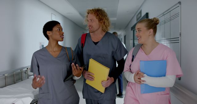 Diverse Healthcare Professionals Collaborating in Hospital Corridor - Download Free Stock Images Pikwizard.com