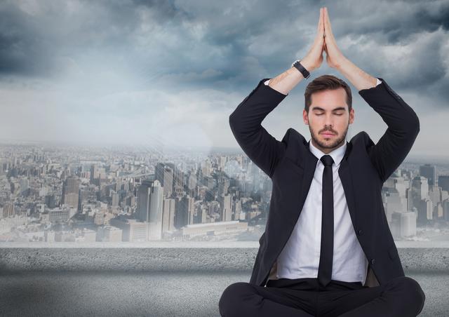 Digital composite of Business man with hands over head meditating against grey skyline and clouds