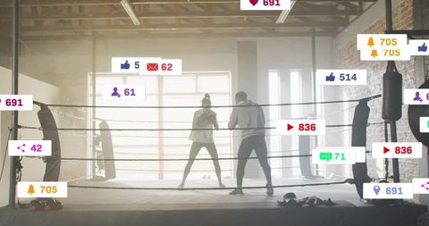 Backlit sparring with coach and boxer in industrial gym overlaid with notification icons
