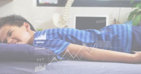Boy undergoing spinal assessment on clinical mattress with medical data hud overlays
