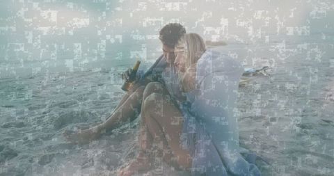 Romantic couple enjoying beach with bottles overlooking sea