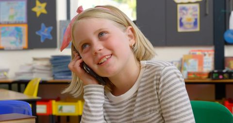 Schoolgirl Talking on Mobile Phone in Classroom