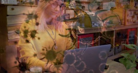 Young Woman Working on Laptop in Cafe with Virus Illustrations Overlay - Download Free Stock Images Pikwizard.com