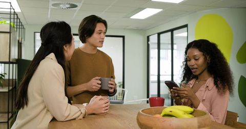 Diverse colleagues engaging in relaxed office conversation