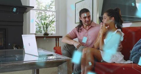Young Couple Experiencing Augmented Reality Romance While Viewing Laptop Hologram at Home