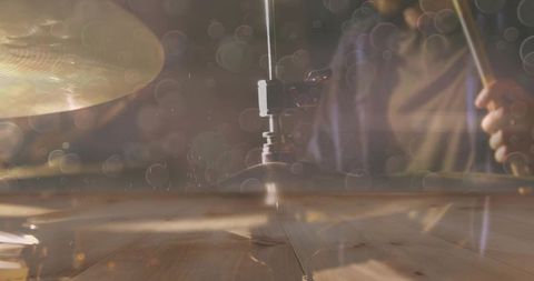 Dynamic drummer striking high-hat on stage with passion and skill