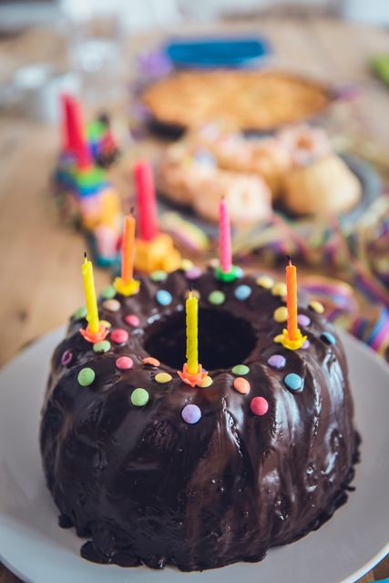 Colorful Birthday Cake with Lit Candles and Chocolate Glaze - Download Free Stock Photos Pikwizard.com