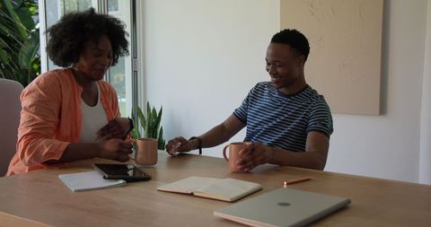 Young Couple Enjoying Coffee and Casual Conversation at Home