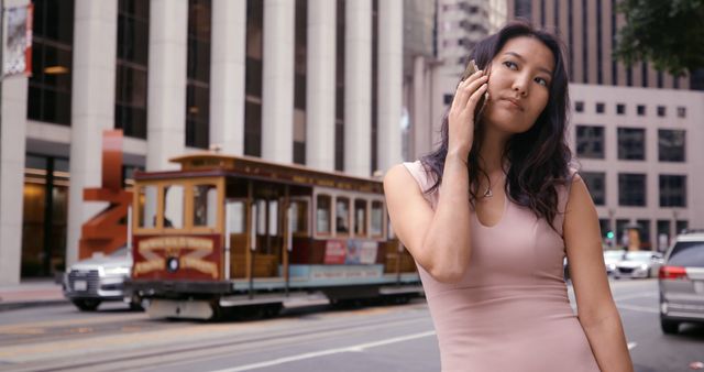 Businesswoman on Phone in Urban Center with Tram in Background - Download Free Stock Images Pikwizard.com