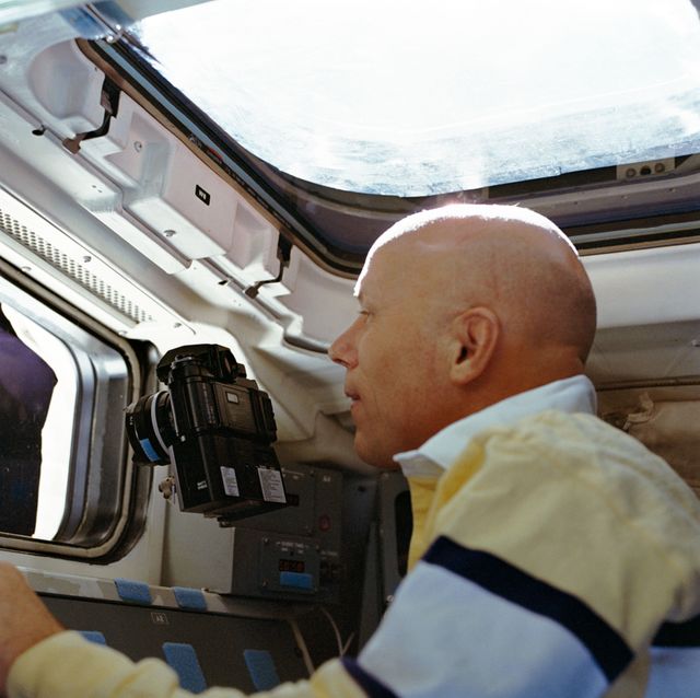 STS-33 Mission Specialist Musgrave points camera out aft flight deck window - Download Free Stock Photos Pikwizard.com