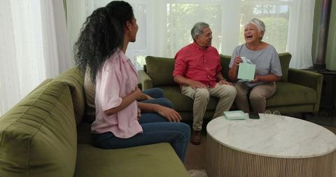 Family Celebrating at Home with Gifts and Laughter