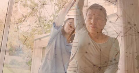 Female Physiotherapist Assisting Patient Amidst Digital Medical Data Overlay