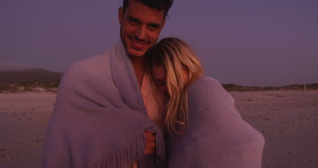 Romantic Couple Wrapped in Blanket During Sunset on Beach - Download Free Stock Images Pikwizard.com