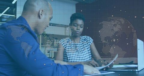 Business Team Reviewing Documents in Modern Office with Digital Map Overlay