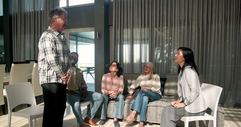 Group therapy session with diverse individuals in collaborative setting